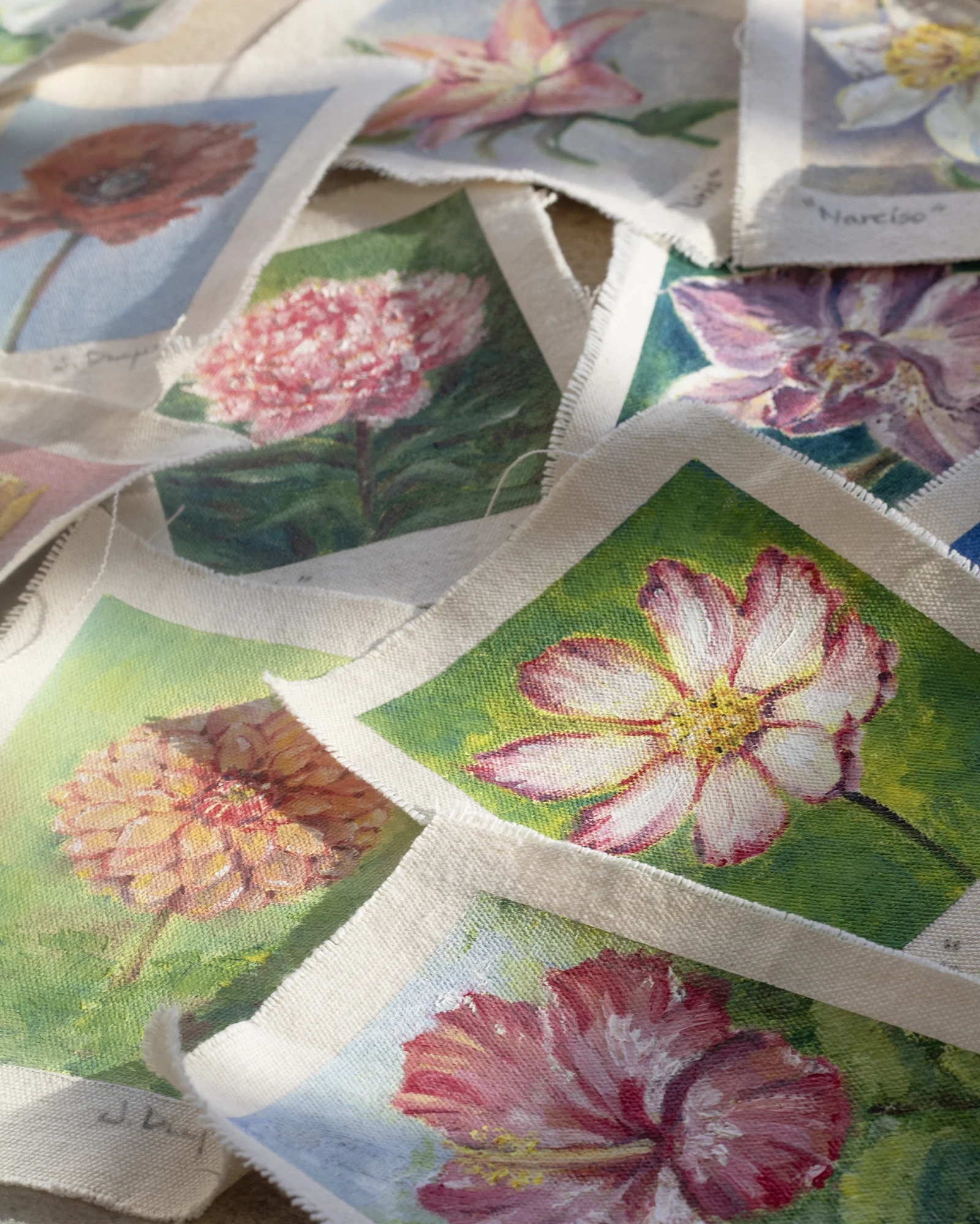 Fifteen oil studies on cotton fabric remnants with raw, frayed edges